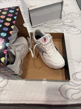 Skechers Rolling Stones White Sneakers with silver charm chains